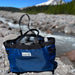 guzzle-h2o-klickitat-bag-front-view-with-filtration-system-beside-stream