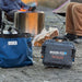 guzzle-h2o-klickitat-bag-front-view-with-stream-with-persons-in-nature