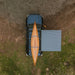 kammok-crosswing-awning-charcoal-5ft-open-drone-view-on-toyota-4runner-in-nature