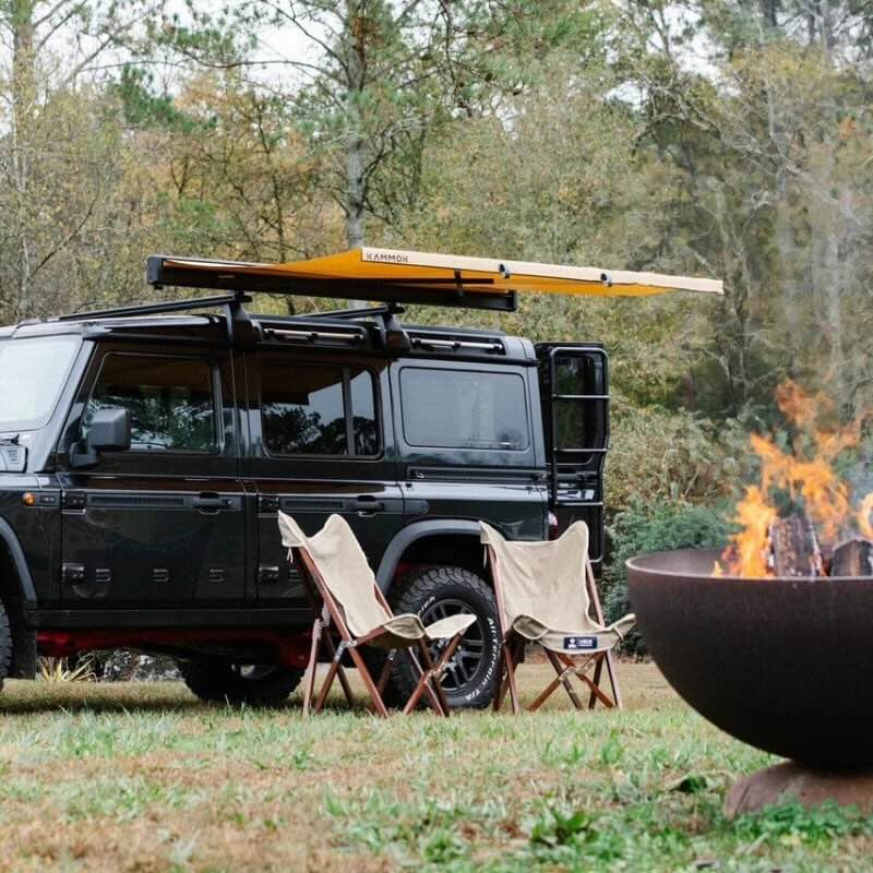 kammok-crosswing-awning-tan-5ft-open-front-corner-view-on-ineos-grenadier-in-nature