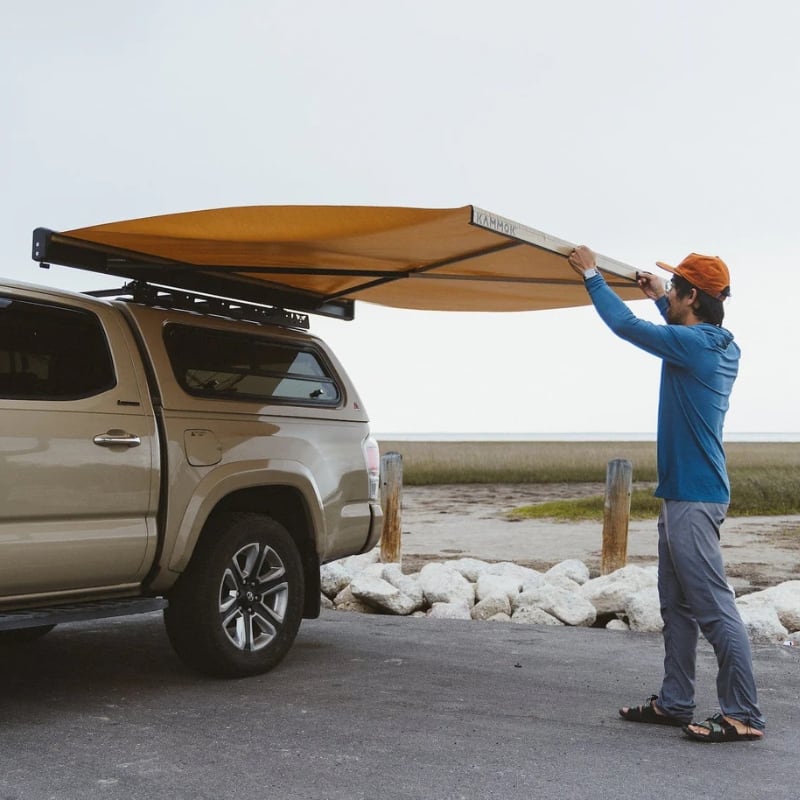 kammok-crosswing-awning-tan-7ft-open-front-corner-view-on-truck-in-nature