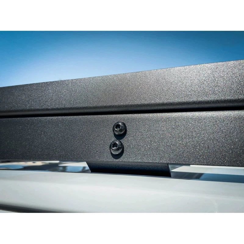 leitner-acs-roof-over-cab-platform-rack-for-gmc-close-up-view-with-mounting-hradware-in-nature