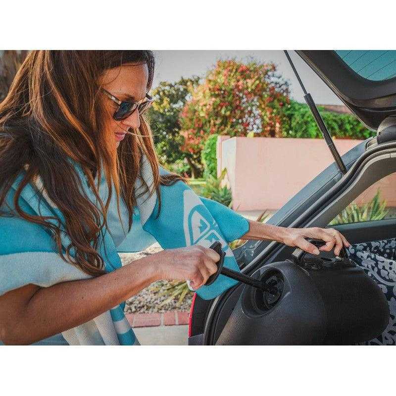 leitner-hydropod-carry-portable-shower-kit-close-up-view-inside-vahicle-with-person-pulling-pump-in-parking-area