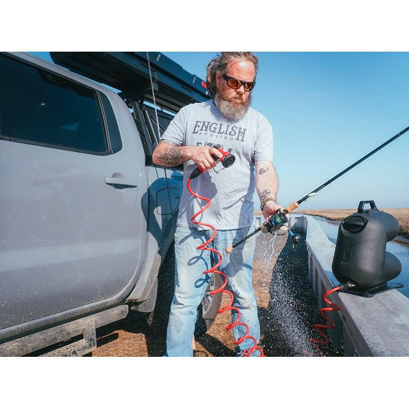 leitner-hydropod-carry-portable-shower-kit-front-corner-view-with-person-wasshing-fishing-rod-in-nature