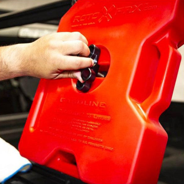 leitner-universal-mounting-plate-close-up-view-on-vehicle-bed-rack-with-hand-mounting-rotopax-in-garage