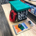 national-luna-dc-25-power-pack-green-front-corner-view-with-wire-and-metal-inclusions-on-table