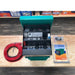 national-luna-dc-25-power-pack-green-front-view-with-wire-and-metal-inclusions-on-table