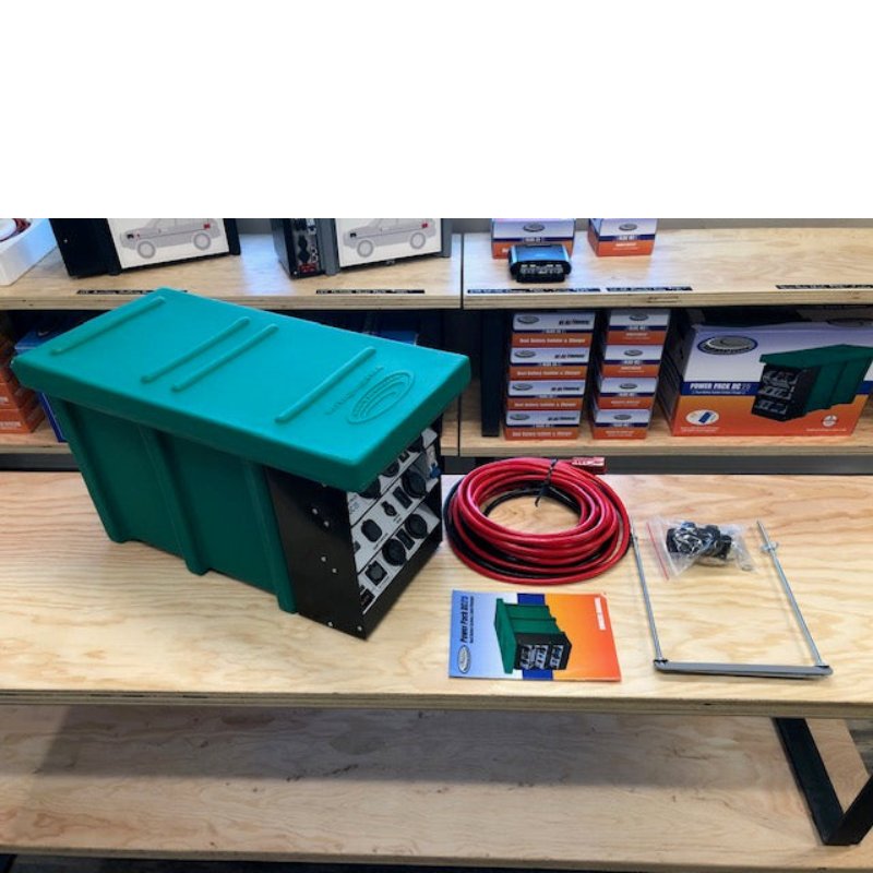 national-luna-dc-25-power-pack-green-top-view-with-inclusions-and-manual-on-table