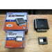national-luna-nldc-25-dc-dc-25-amp-charger-top-view-with-lcd-monitor-and-cardboard-packaging-on-top-of-table
