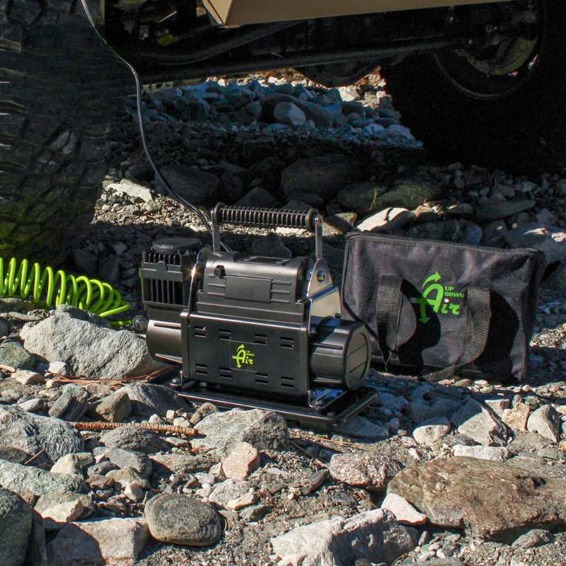 overland-vehicle-systems-egoi-portable-air-compressor-with-control-panel-back-view-with-bag-below-vehicle