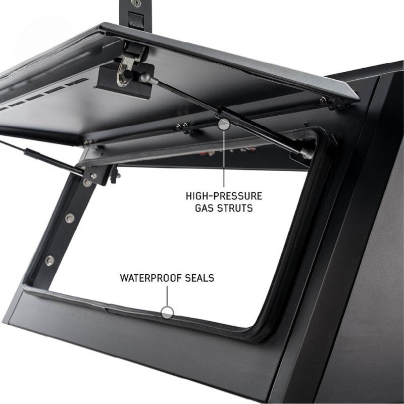 overland-vehicle-systems-expedition-truck-cap-for-2023-2024-ford-f-250-350-black-close-up-view-opened-door-struts-white-background
