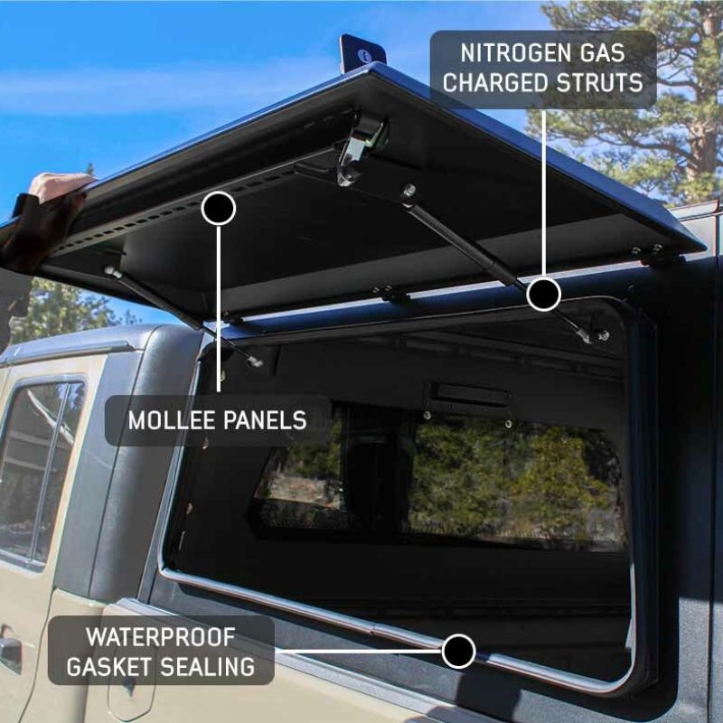overland-vehicle-systems-expedition-truck-cap-for-ford-ranger-black-side-view-opened-doors-construction-and-waterproof-seal-on-white-background