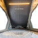 overland-vehicle-systems-magpak-camper-shell-roof-top-tent-for-toyota-tacoma-open-interior-view-led-light-package-on-white-background