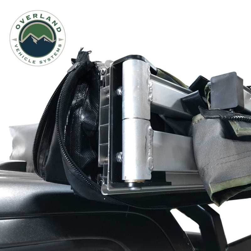 overland-vehicle-systems-nomadic-270-awning-driverside-open-close-up-view-of-aluminum-frame-box-hinge-and-steel-hardware-on-neutral-background