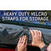 overland-vehicle-systems-nomadic-awning-180-lte-gray-closed-with-hand-holding-velcro-strap-in-nature