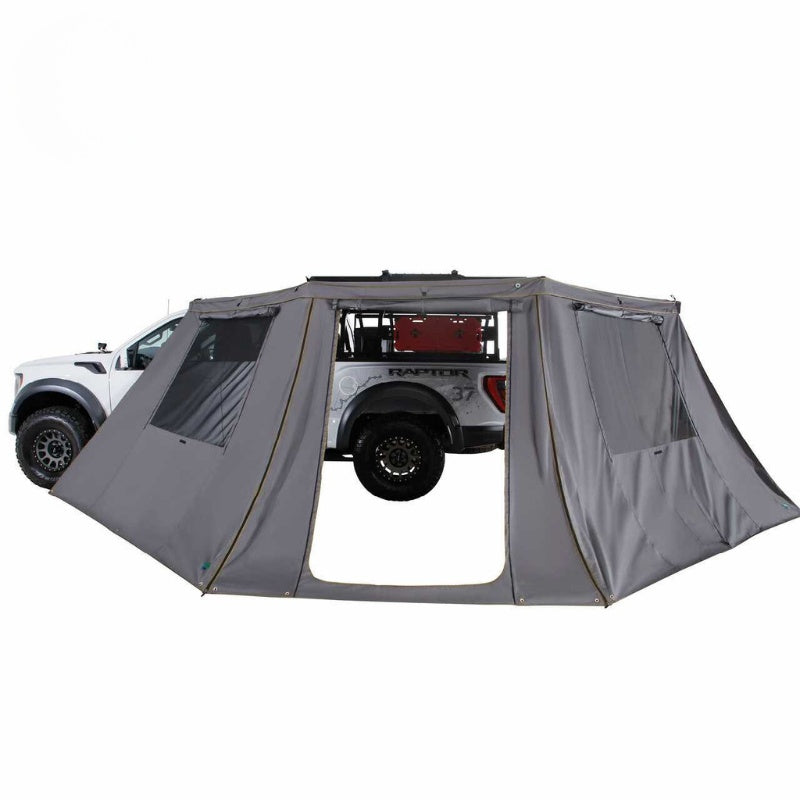 overland-vehicle-systems-nomadic-awning-180-lte-gray-open-side-view-on-ford-raptor-with-awning-wall-on-white-background