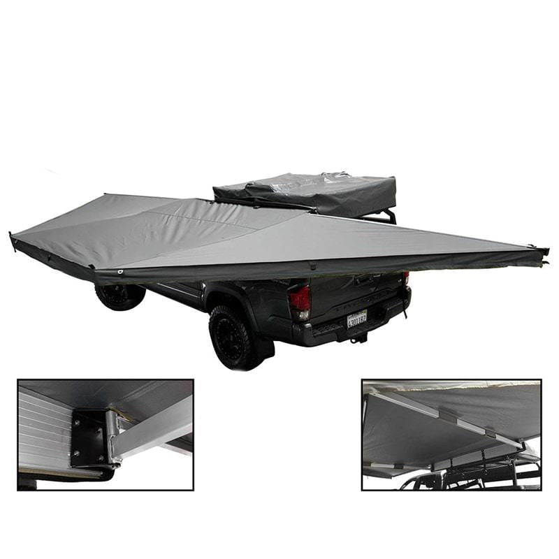 overland-vehicle-systems-nomadic-awning-180-with-zip-in-wall-dark-gray-open-rear-corner-view-on-toyota-tacoma-on-white-background