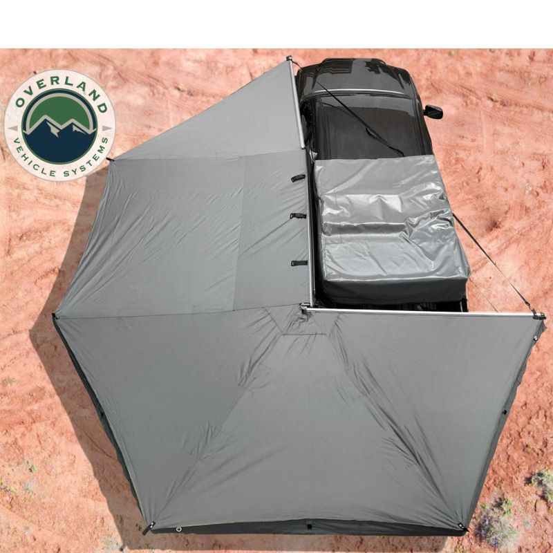 overland-vehicle-systems-nomadic-awning-270-driver-side-gray-open-top-view-on-toyota-tacoma-in-desert