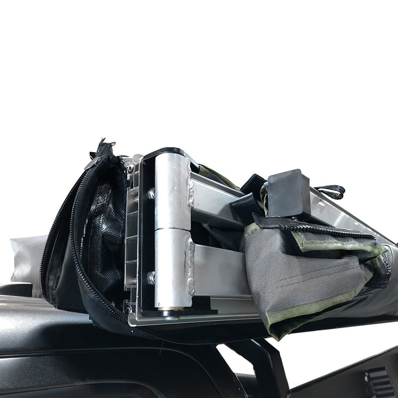 overland-vehicle-systems-nomadic-awning-270-for-mid-high-roofline-vans-driver-side-closed-close-up-view-of-hinge