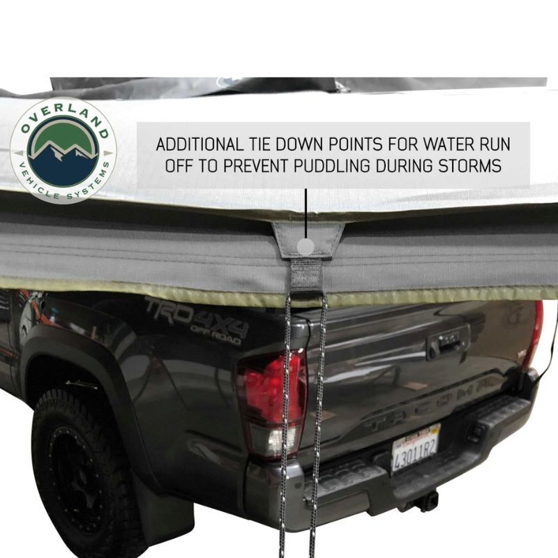 overland-vehicle-systems-nomadic-awning-270-passenger-side-gray-open-with-tie-down-points-description-on-toyota-tacoma