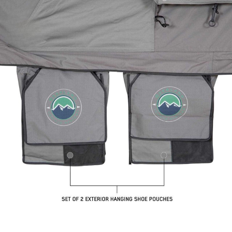 overland-vehicle-systems-nomadic-extended-soft-shell-roof-top-tent-grey-open-close-up-veiw-shoe-pouches-on-white-bakground