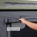 overland-vehicle-systems-nomadic-extended-soft-shell-roof-top-tent-grey-open-close-up-view-with-hand-holding-window-cover