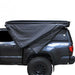 overland-vehicle-systems-xd-nomadic-270-degree-awning-black-closed-side-view-on-toyota-tacoma-with-truck-cap-on-white-background
