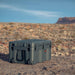 roam-125l-rolling-rugged-case-slate-corner-front-view-on-terrain