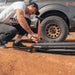 roam-7-gallon-water-tank-close-up-view-with-person-pumping-on-desert