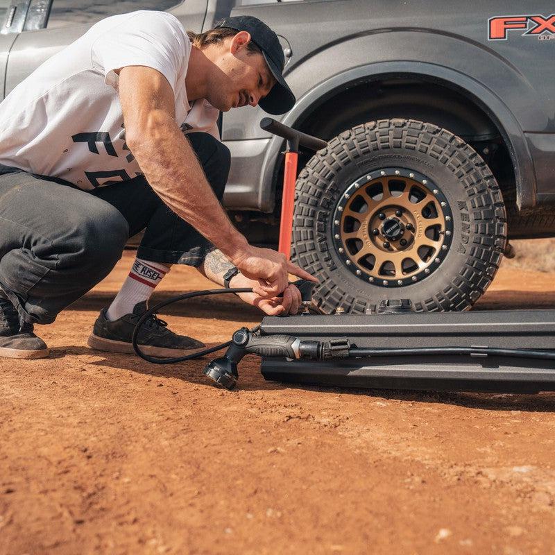 roam-7-gallon-water-tank-close-up-view-with-person-pumping-on-desert