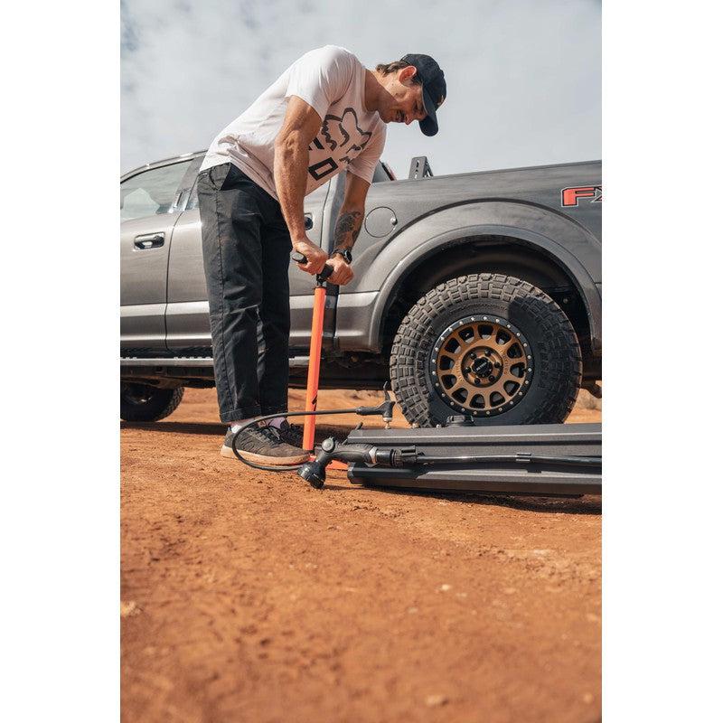 roam-7-gallon-water-tank-close-up-view-with-person-pumping-on-terrain