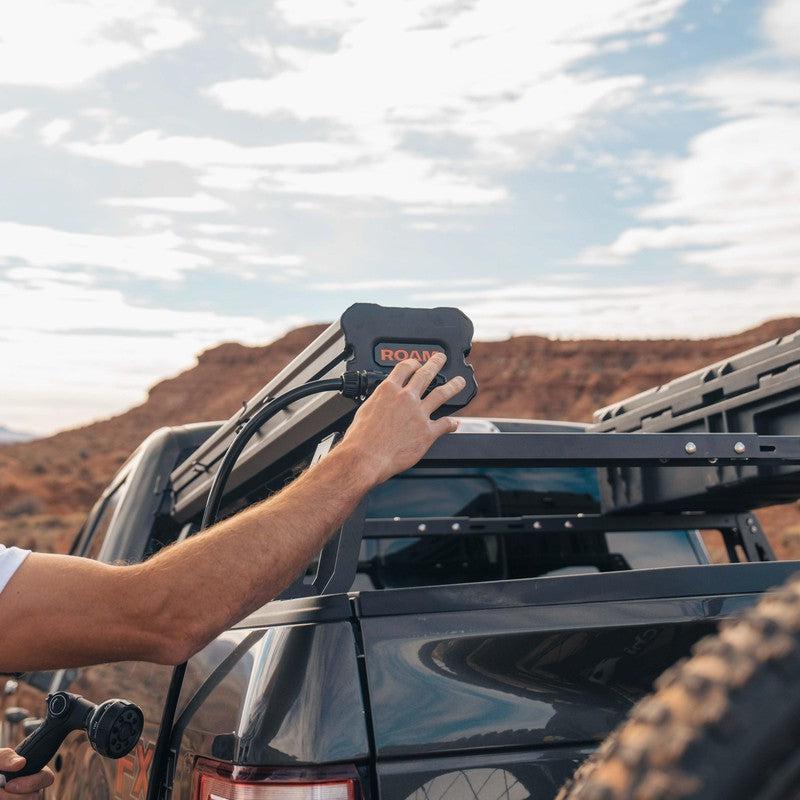 roam-7-gallon-water-tank-side-view-with-person-on-terrain
