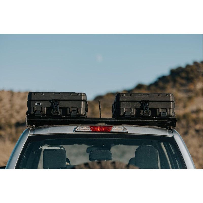 roam-83l-rugged-case-black-side-view-on-vehicle-in-nature