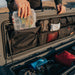 roam-95l-lid-organizer-clpse-up-view-on-rugged-case-with-person-in-nature
