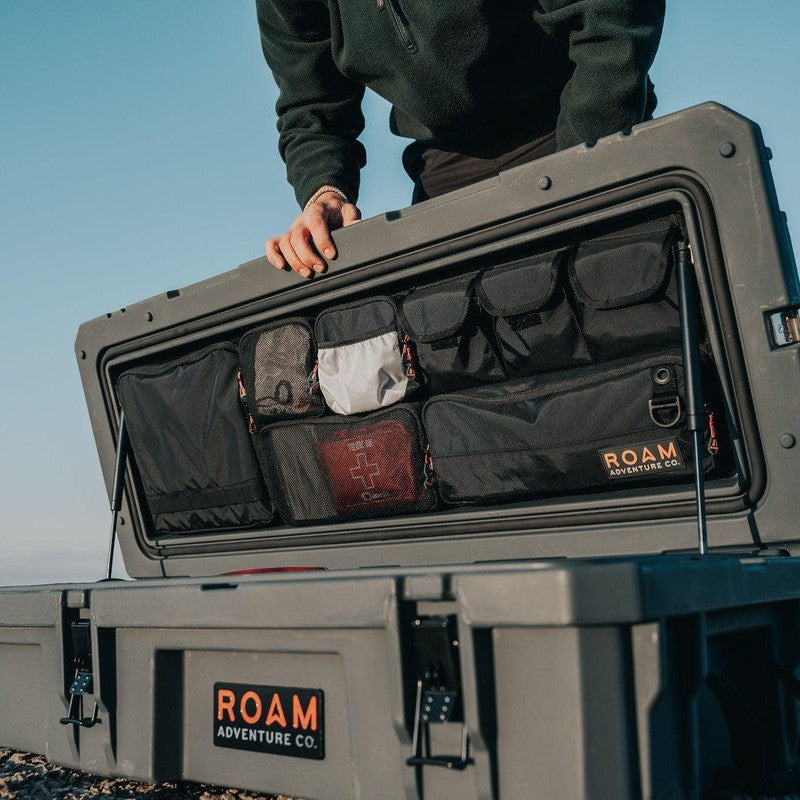 roam-95l-lid-organizer-front-corner-view-on-rugged-case-with-person-in-nature