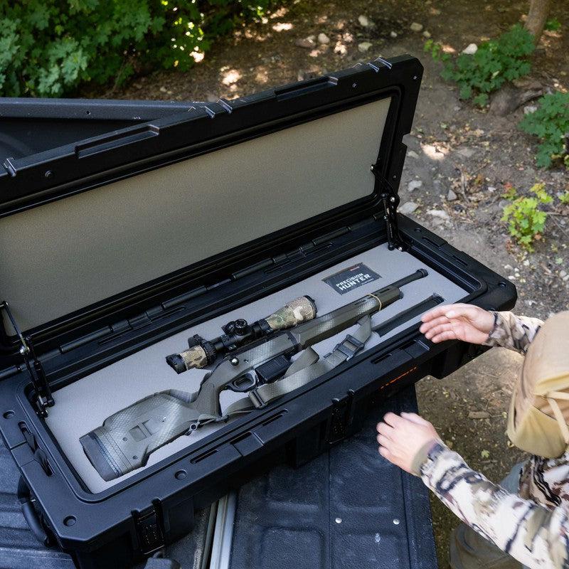roam-95l-rugged-case-foam-insert-front-corner-view-in-rugged-case-with-person-with-weapon-in-nature