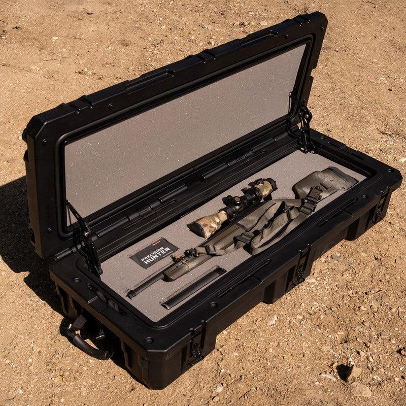 roam-95l-rugged-case-foam-insert-front-corner-view-in-rugged-case-with-weapon-on-desert