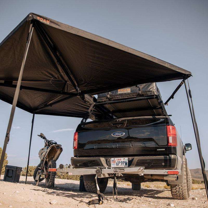 roam-arc-270-awning-driver-side-open-interior-view-with-motorcycle-and-roam-case-in-nature