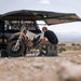 roam-arc-270-awning-driver-side-open-interior-view-with-person-in-nature