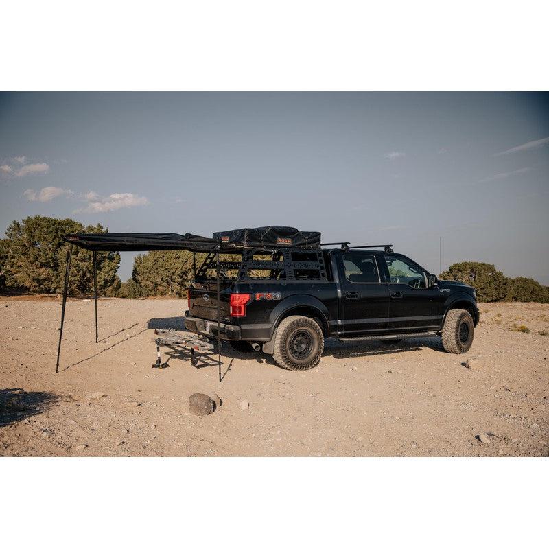 roam-arc-270-awning-driver-side-rear-corner-view-with-rooftop-tent-in-nature