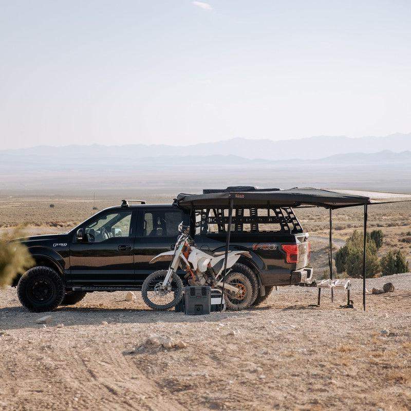 roam-arc-270-awning-driver-side-open-side-view-with-motorcycle-and-roam-case-in-nature