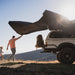 roam-arc-270-awning-passenger-side-open-side-view-with-person-opening-awning-in-nature