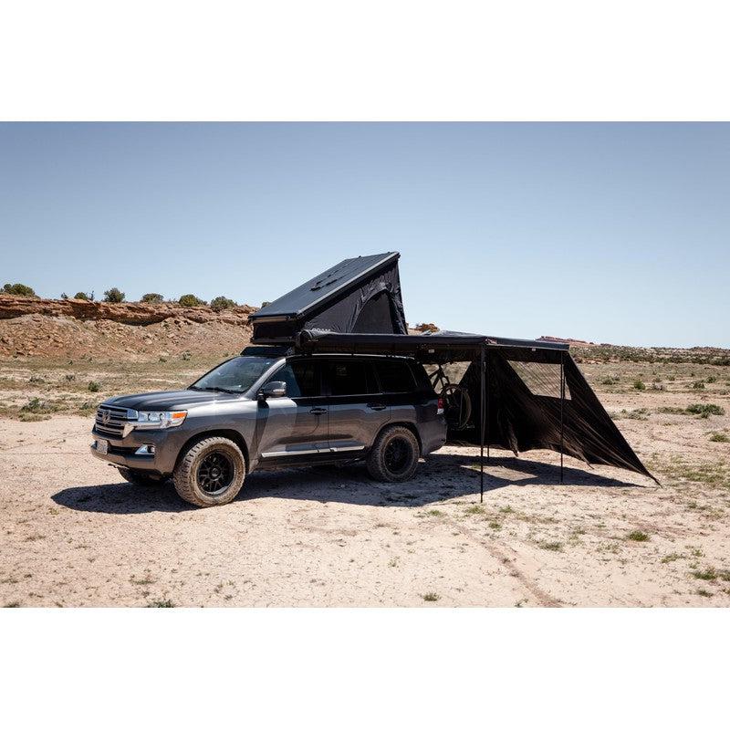 roam-arc-270-awning-wall-kit-front-corner-view-with-rooftop-tent-in-terrain