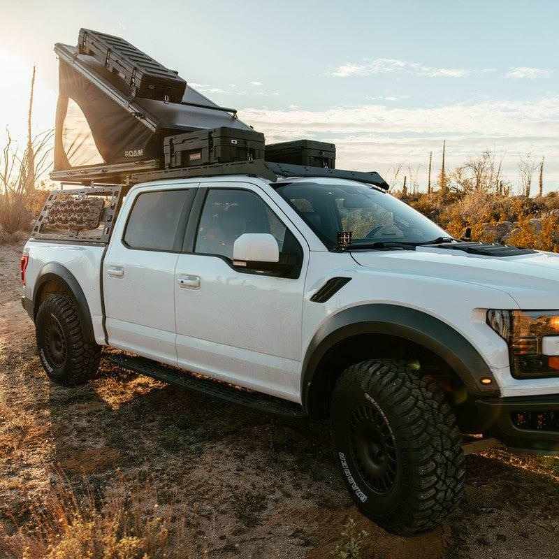 roam-desperado-hardshell-rooftop-tent-open-rear-corner-view-on-vehicle-in-nature