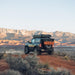 roam-rambler-hardshell-rooftop-tent-closed-rear-view-in-terrain