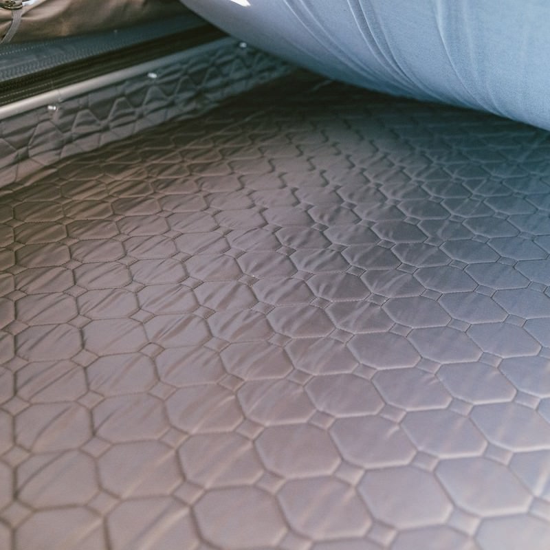 roam-rambler-hardshell-rooftop-tent-open-close-up-view-with-insulated-floor