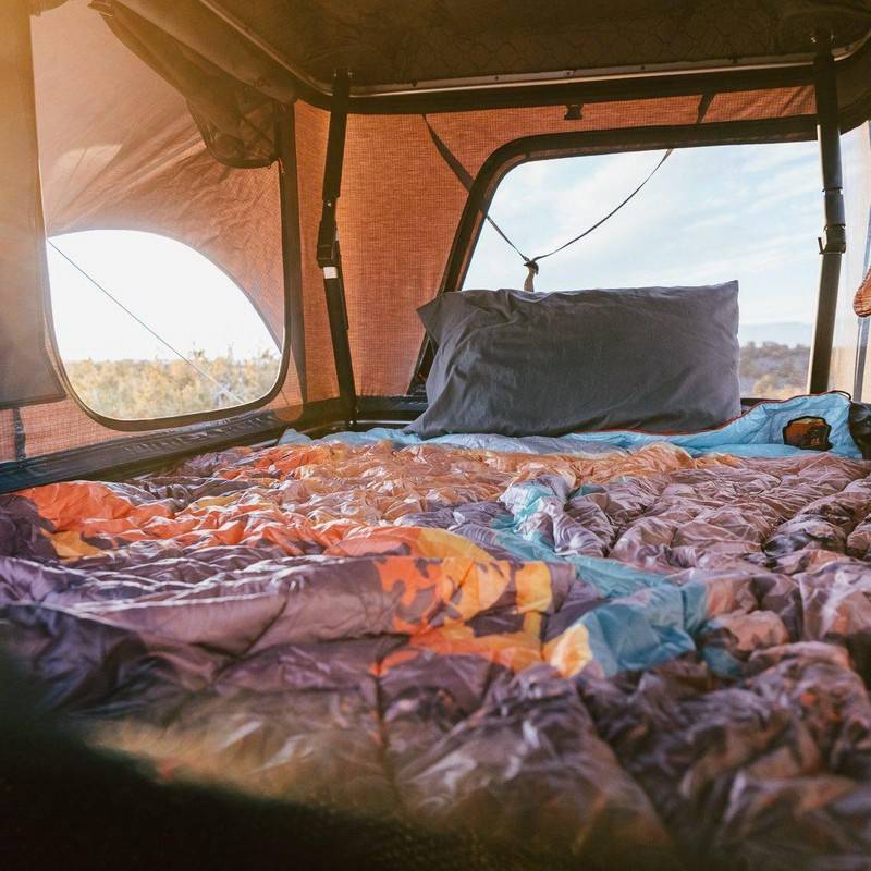 roam-rambler-hardshell-rooftop-tent-open-interior-view-with-panoramic-windows-in-nature