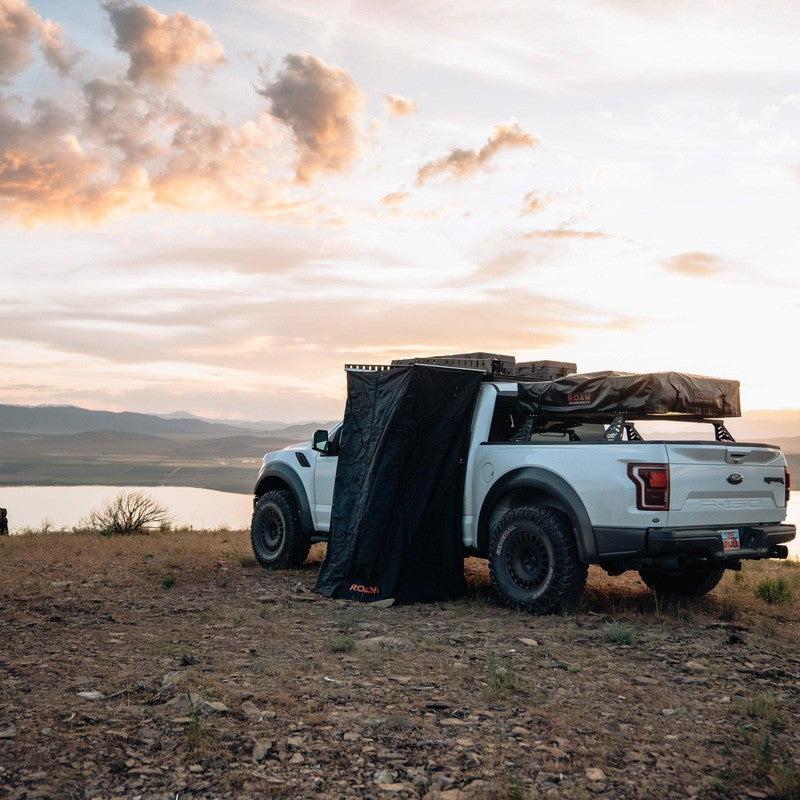 roam-shower-room-front-corner-view-with-vehicle-in-nature