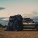roam-vagabond-tent-annex-room-black-open-front-corner-view-on-vehicle-in-nature
