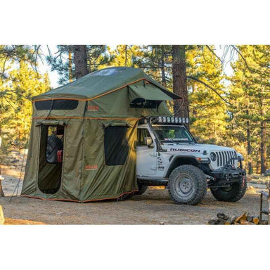 roam-vagabond-tent-annex-room-forest-green-hyper-orange-open-front-corner-view-on-vehicle-in-nature